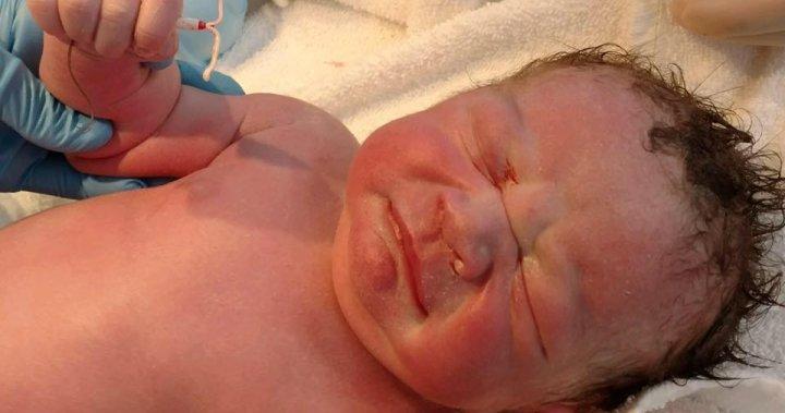 ‘Mirena baby’ photographed clutching his mother’s IUD after birth