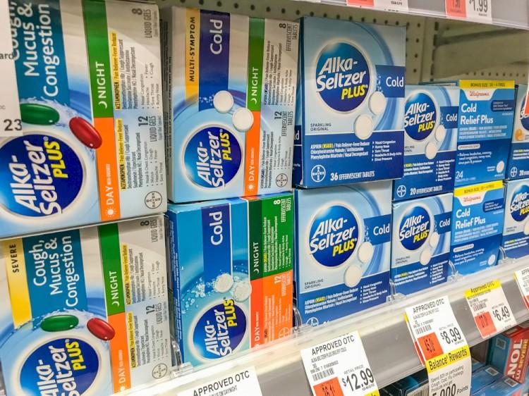 Packs of Alka-Seltzer stand on a shelf in a drug store