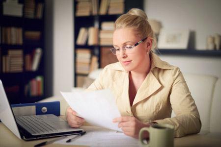 mental health counselor looking at paperwork in her office