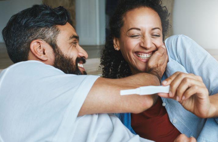 Couple is excited for the pregnancy test woman is holding