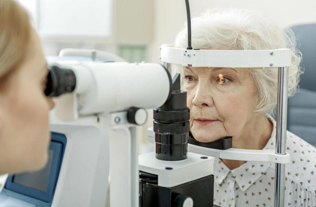 Close-up of an older woman undergoing a slit-lamp exam.